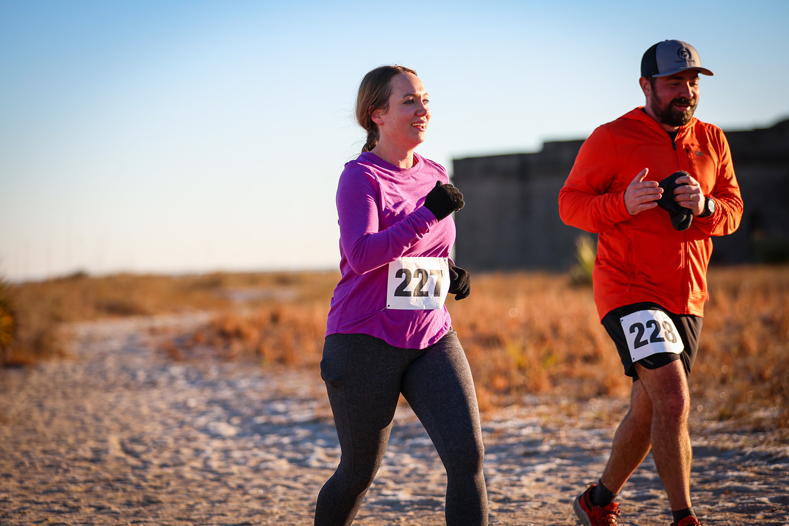Man and woman running together on coastal trail